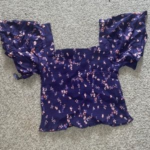 It is a ribbed elastic blouse/crop top with pretty floral design.